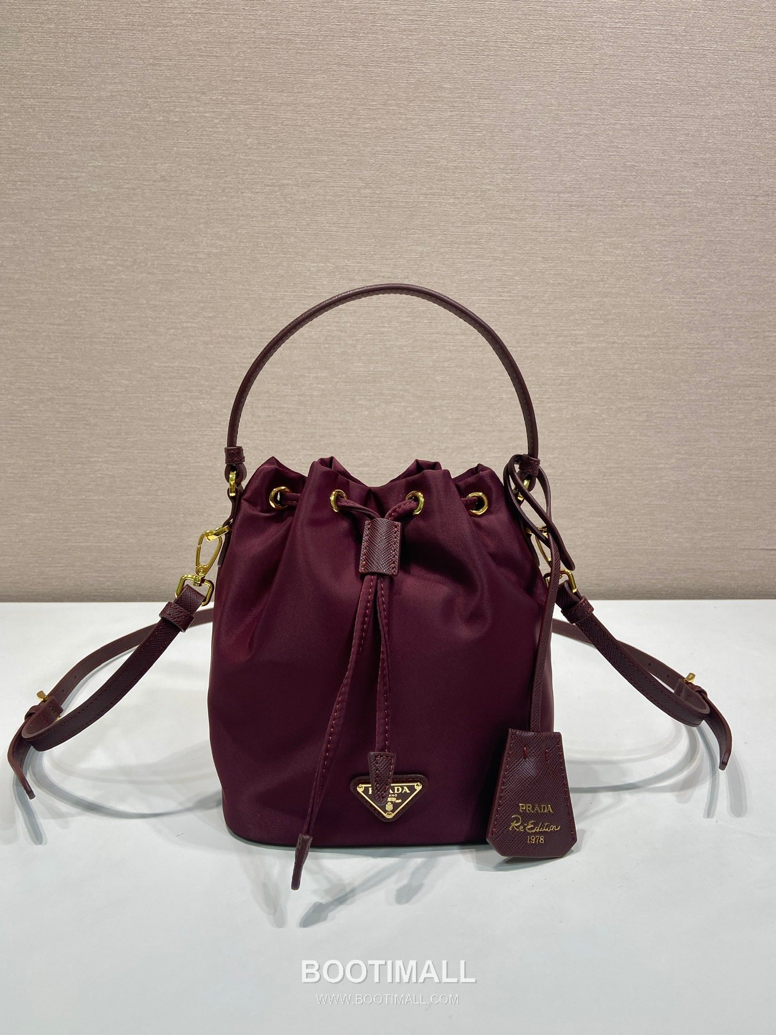 Prada Nylon Bucket Bag with Calfskin Strap Triangle Logo Key Charm Detail 프라다 나일론 카프스킨 스트랩 트라이앵글 로고 키참 버킷백 1BE067 15.5cm 1