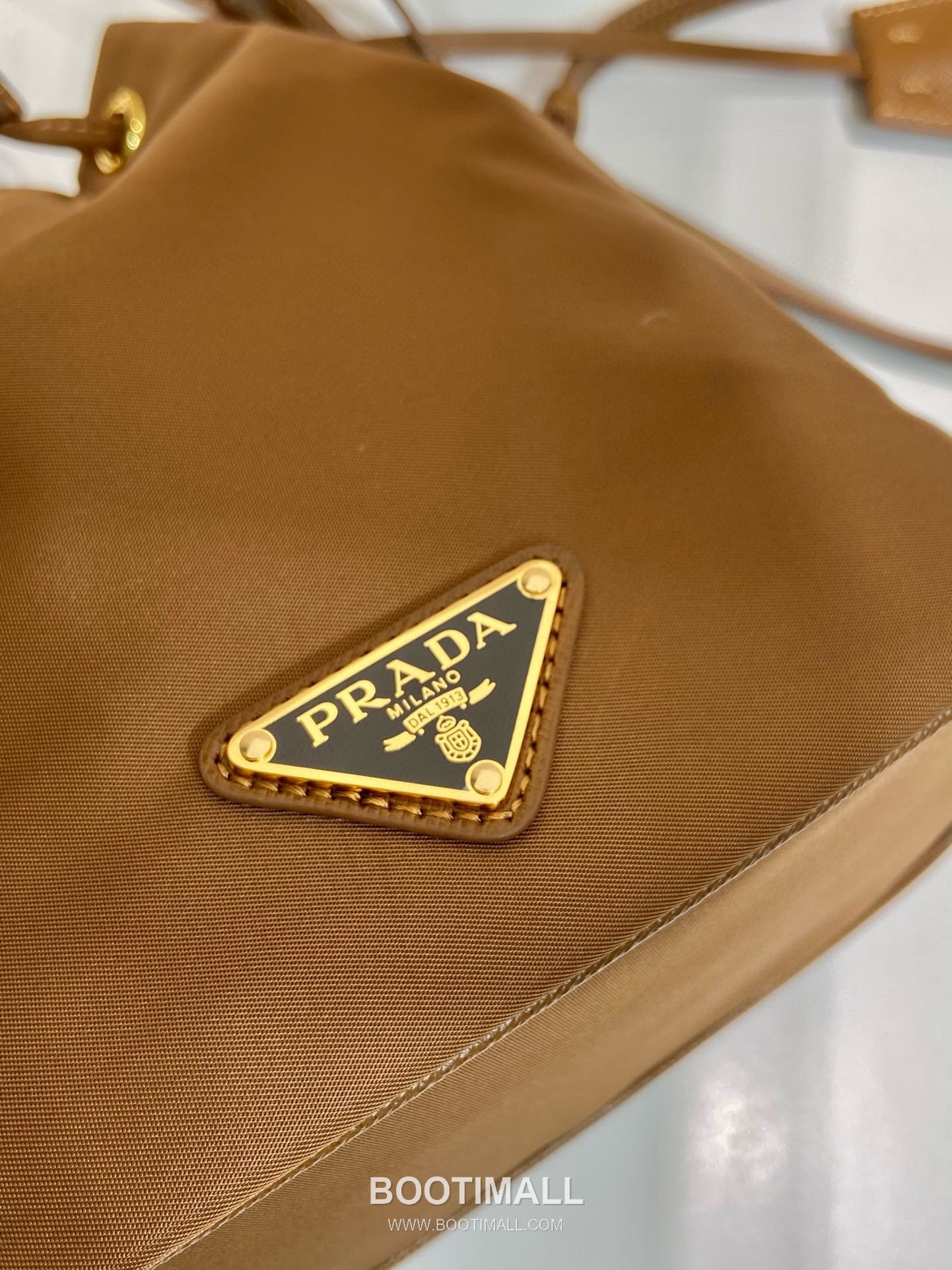 Prada Nylon Bucket Bag with Calfskin Strap Triangle Logo Key Charm Detail 프라다 나일론 카프스킨 스트랩 트라이앵글 로고 키참 버킷백 1BE067 15.5cm 15