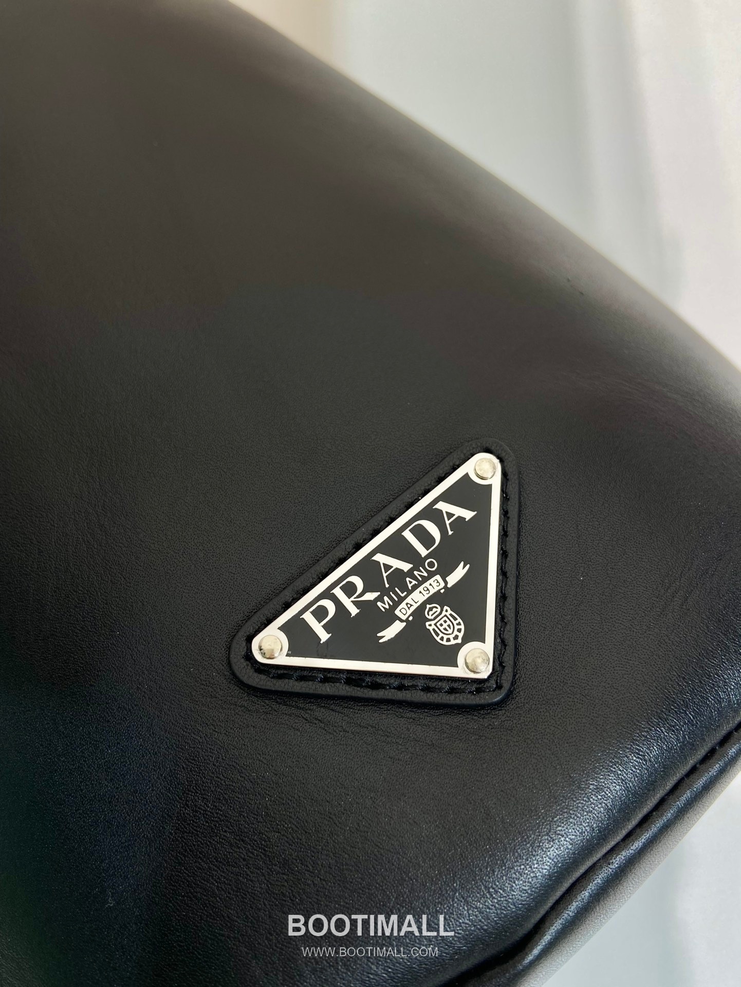 Prada Nappa Leather Sling Backpack with Embossed Logo Detail 프라다 나파 레더 엠보싱 로고 슬링 백팩 2VZ098 17cm 6